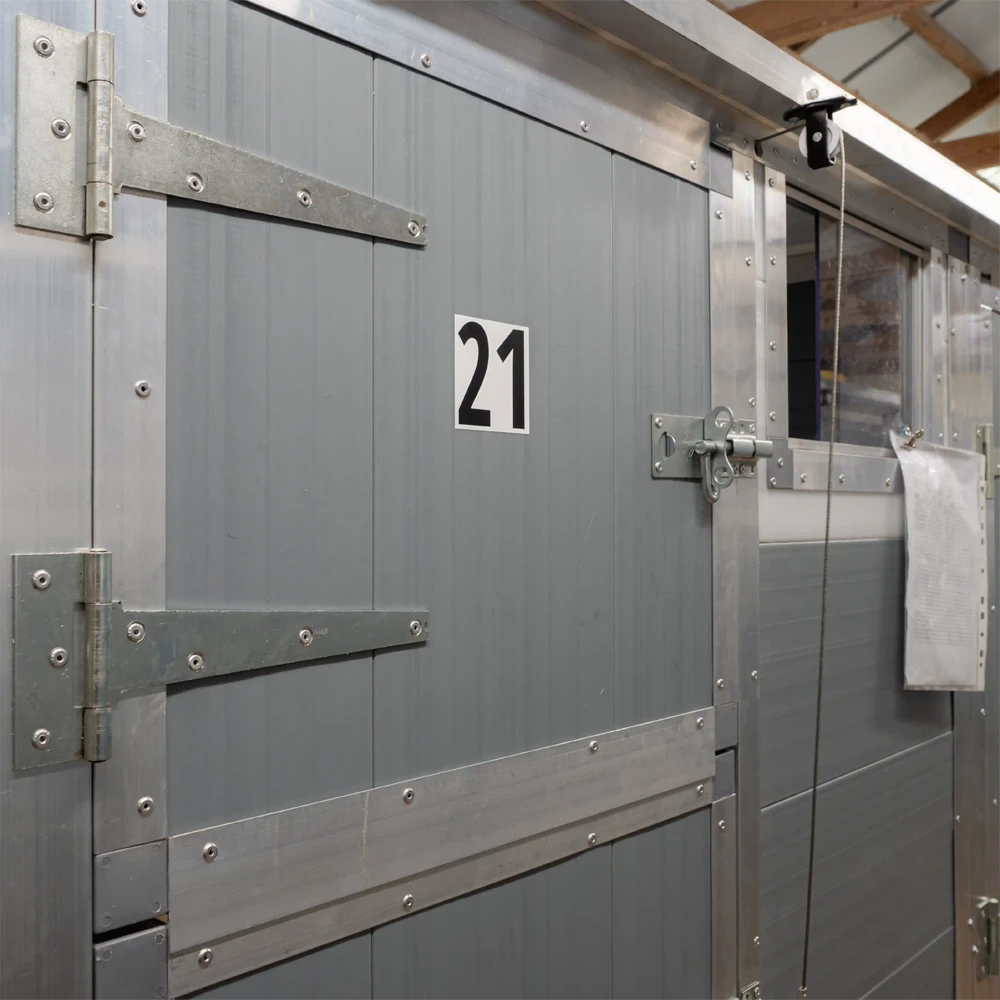 Secure kennel door leading to a private covered run